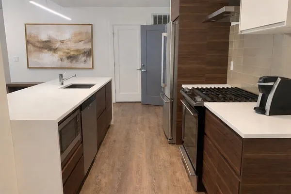 a kitchen with a sink stove and refrigerator