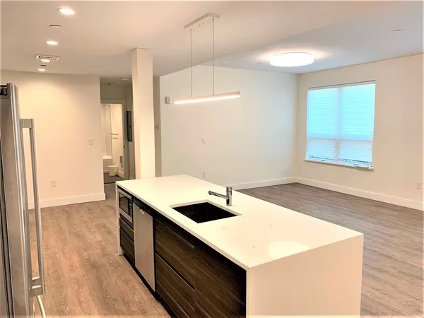 a kitchen that has a microwave a sink and a stove in it