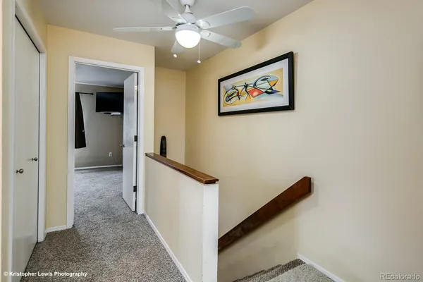 a view of a hallway with paintings on the wall