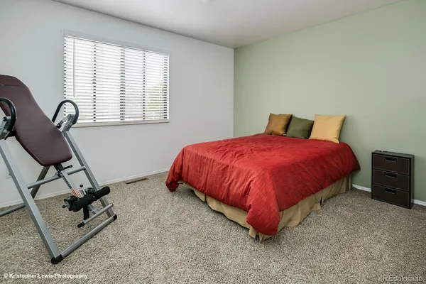 a bedroom with a bed chair and window