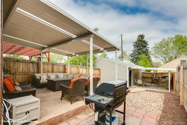 a view of a patio with a table chairs and a backyard