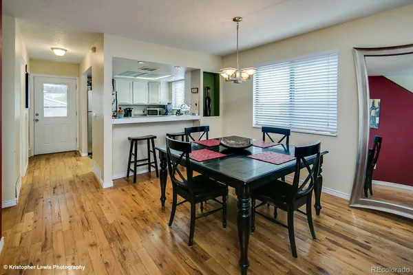 a view of a dining room with furniture and wooden floor