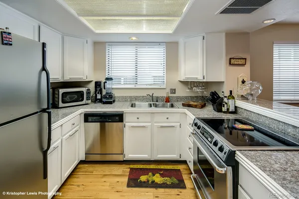 a kitchen with a sink stove and refrigerator
