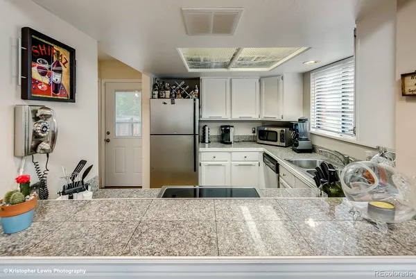 a kitchen with a refrigerator and a sink