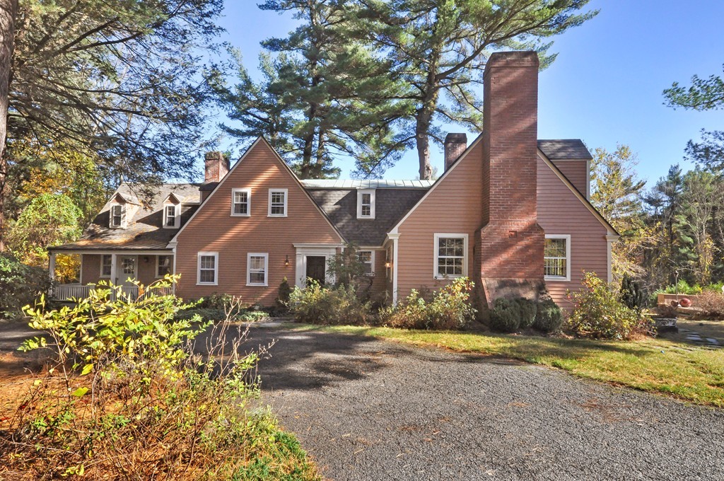 a front view of house with yard and trees around