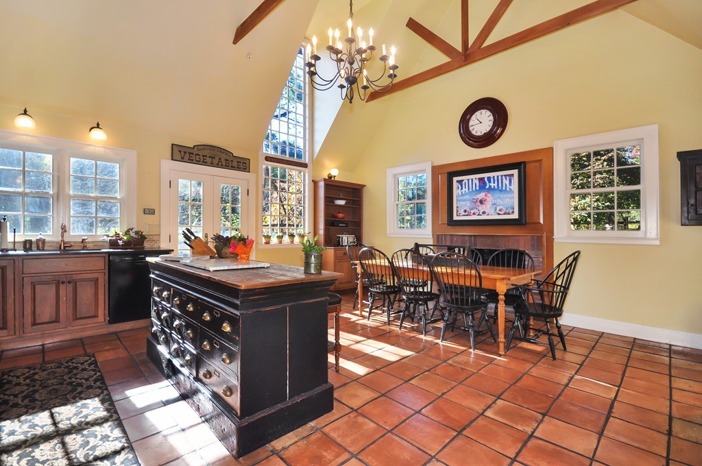315 Garfield Road Concord, MA 01742 - Photo 2 of 21 a view of a dining room with furniture and a clock