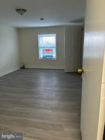 an empty room with wooden floor
