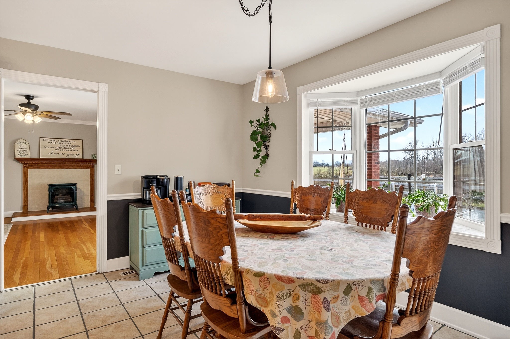 597 Game Ridge Road Smithville, TN 37166 - Photo 14 of 45 a dining room with furniture a floor to ceiling window and potted plants