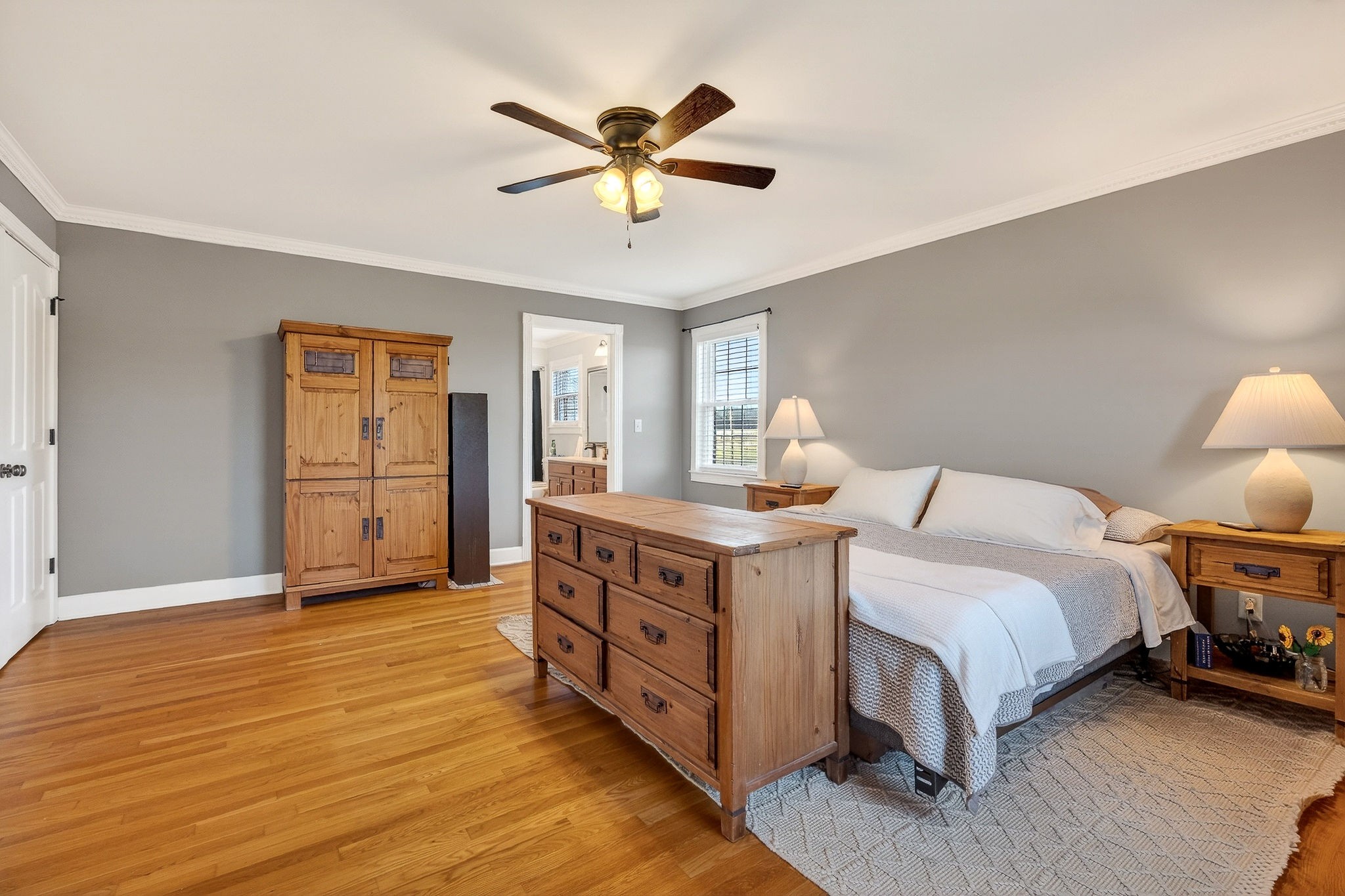 597 Game Ridge Road Smithville, TN 37166 - Photo 20 of 45 a spacious bedroom with a bed and a chandelier