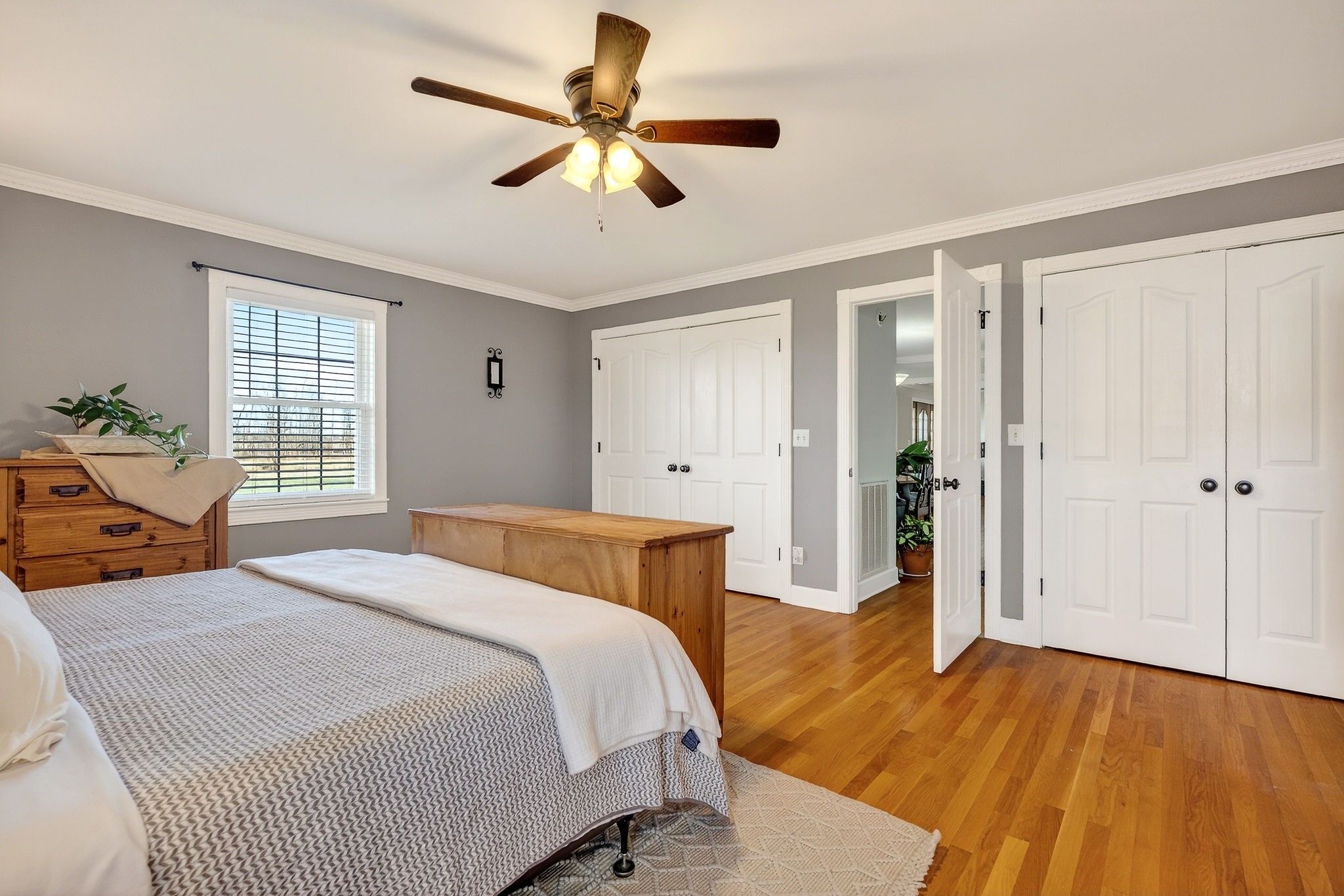 597 Game Ridge Road Smithville, TN 37166 - Photo 21 of 45 a bedroom with a large bed chandelier and a window