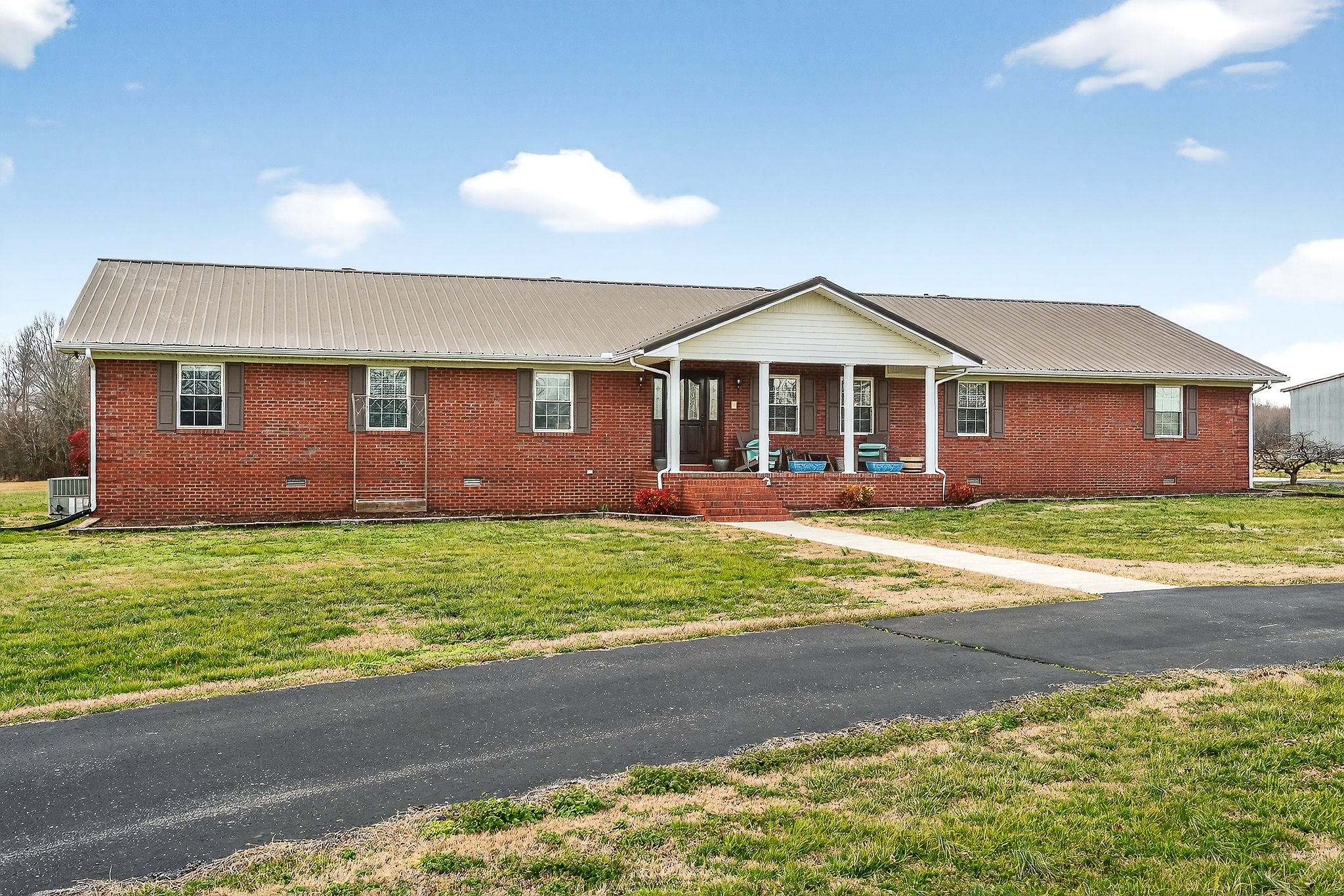 597 Game Ridge Road Smithville, TN 37166 - Photo 41 of 45 a front view of a house with a garden and yard