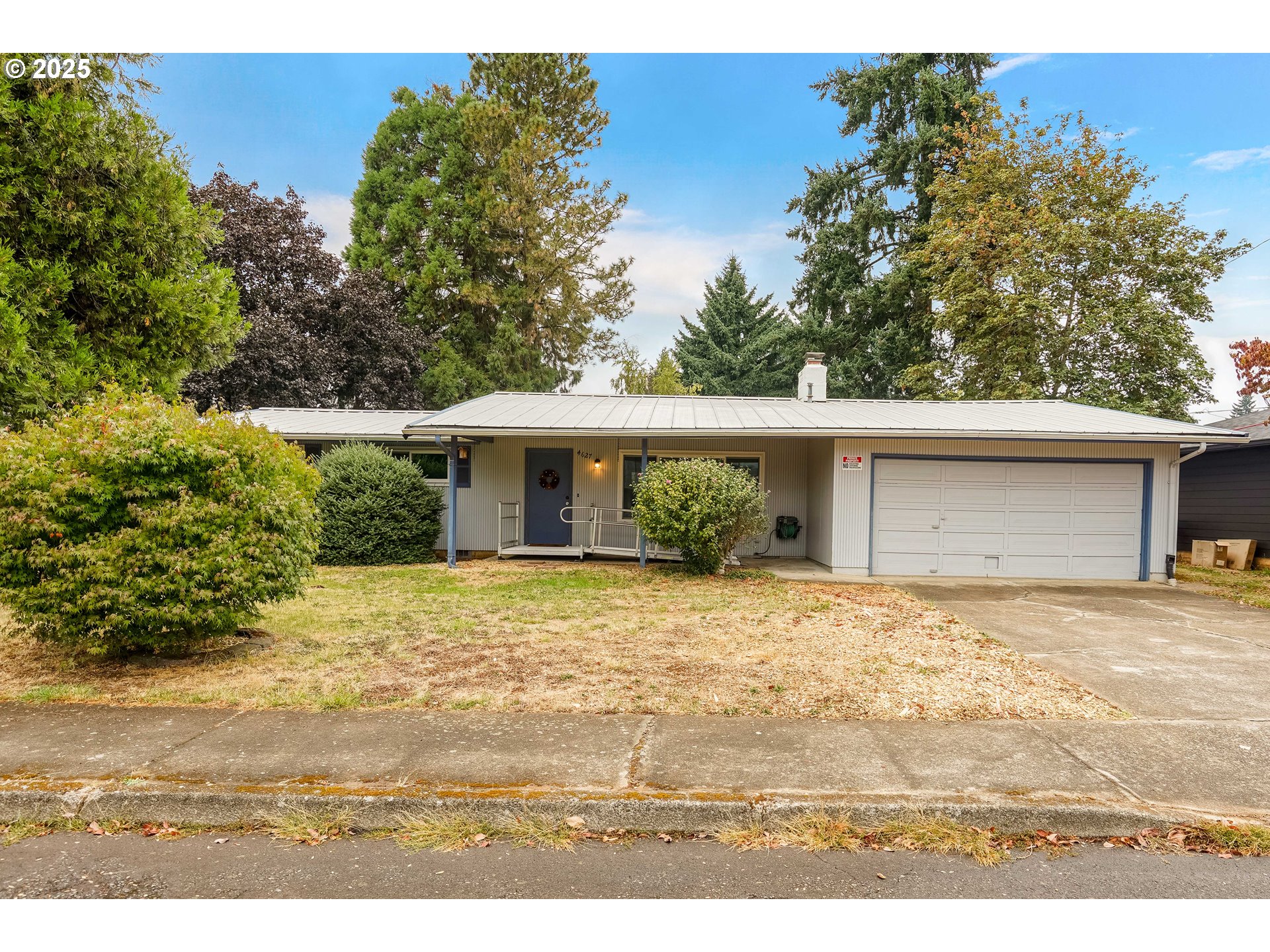 a front view of a house with a garden