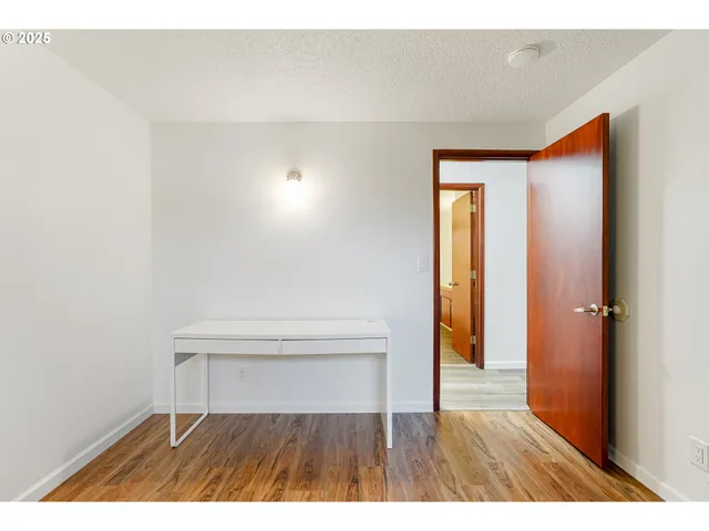 a view of an empty room and wooden floor