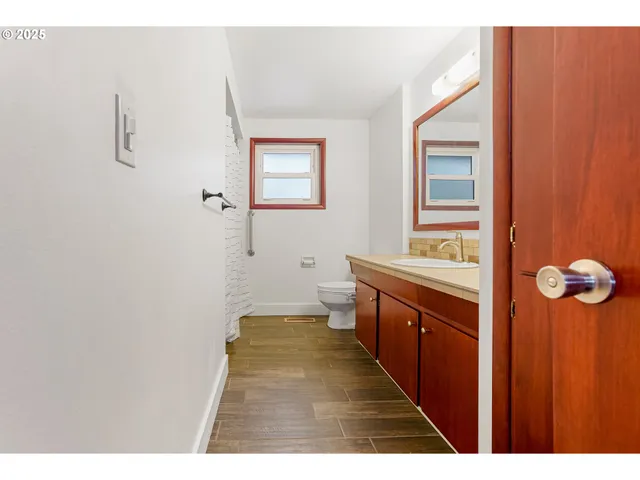 a bathroom with a sink a mirror and a toilet
