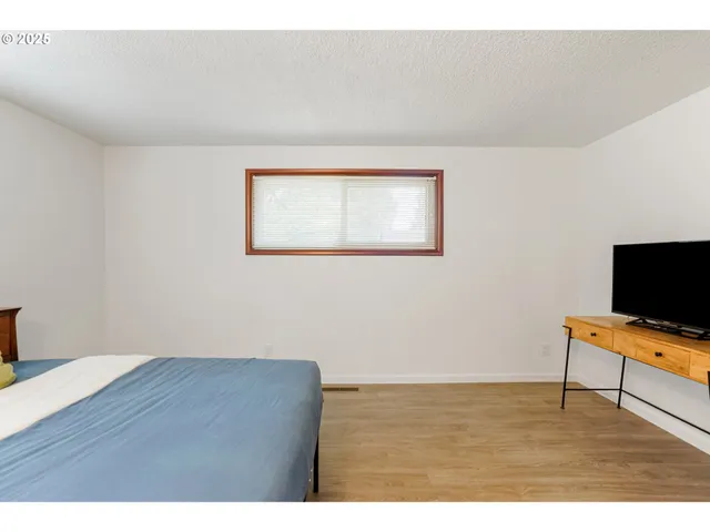 a bedroom with a bed and a flat screen tv