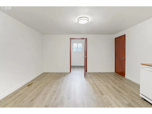 a view of an empty room and wooden floor