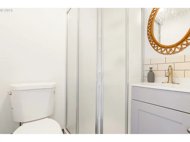 a bathroom with a toilet a sink and a mirror