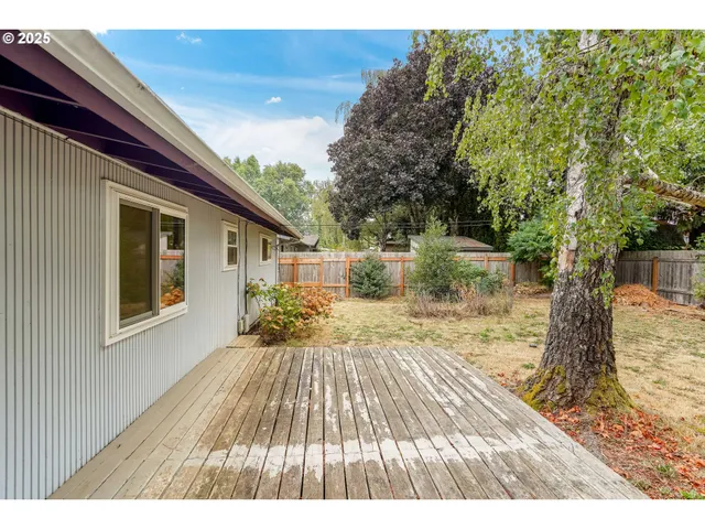 a view of backyard with a deck and wooden floor