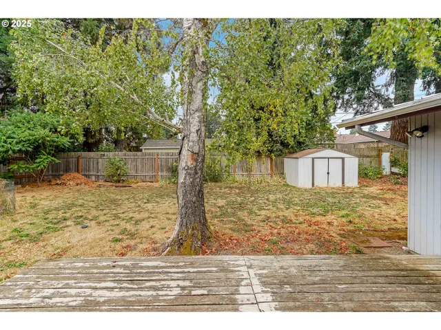 a view of a wooden house with a yard