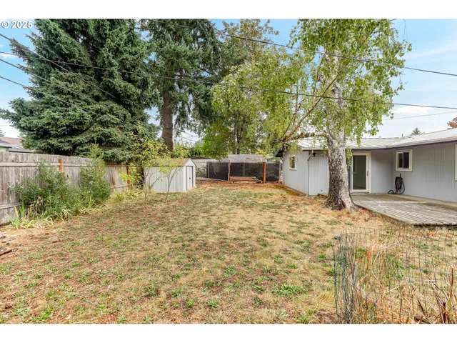 a backyard of a house with table and chairs