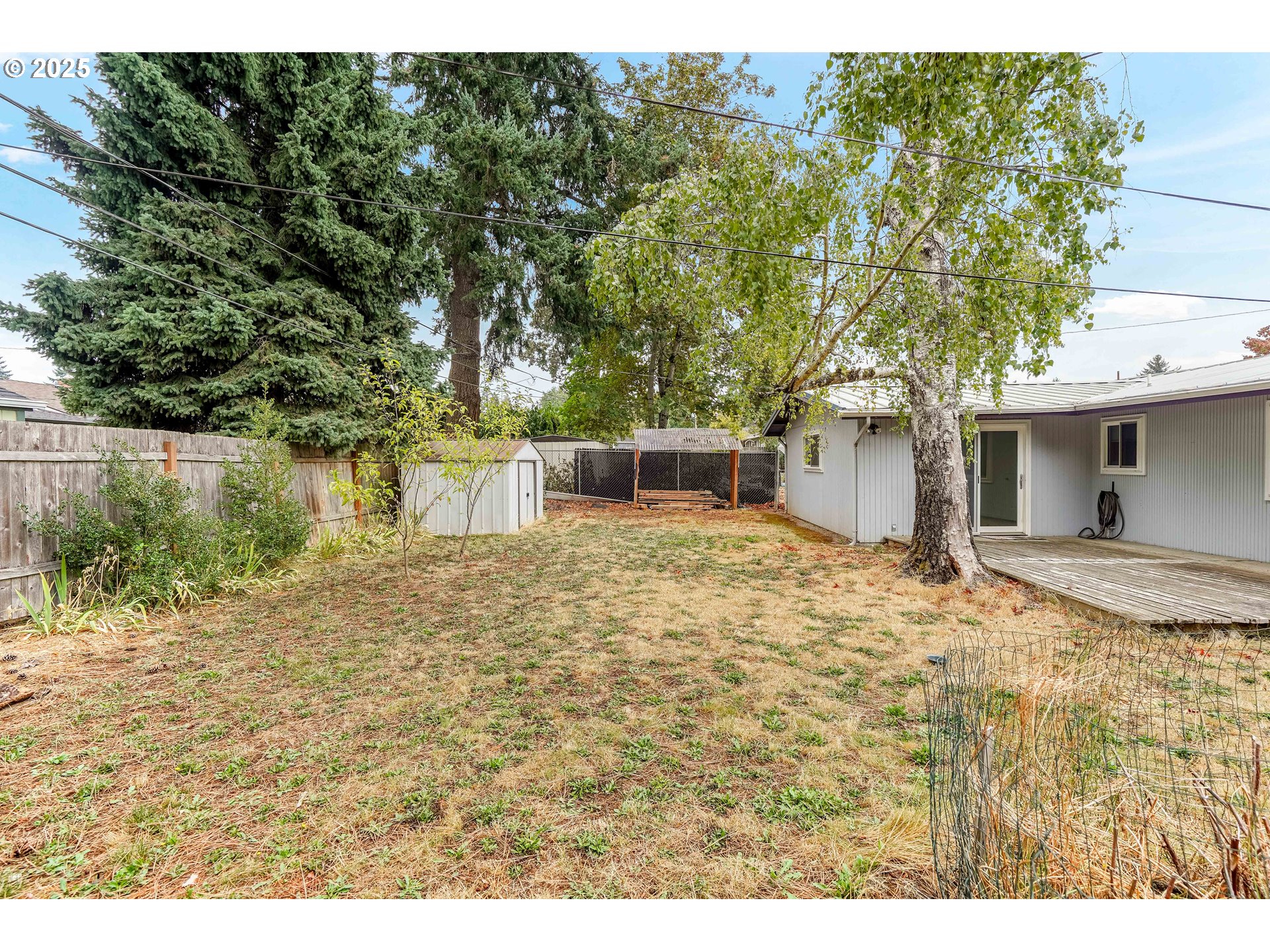 4627 2nd Way Southeast Salem, OR 97302 - Photo 44 of 48 a backyard of a house with large trees and wooden fence