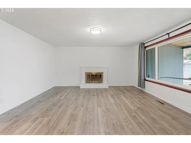 a view of room with wooden floor and window