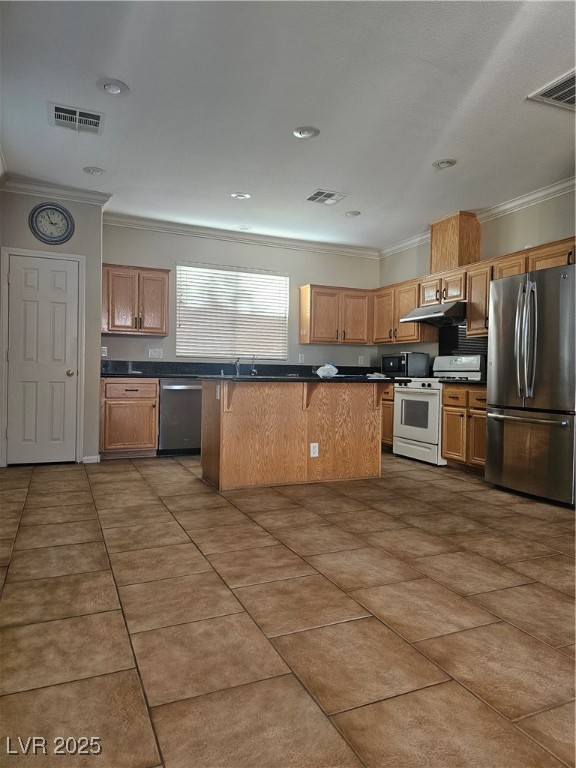 11081 Village Ridge Lane Las Vegas, NV 89135 - Photo 11 of 14 Kitchen featuring crown molding, fridge, dark countertops, stove, and dark tile patterned flooring
