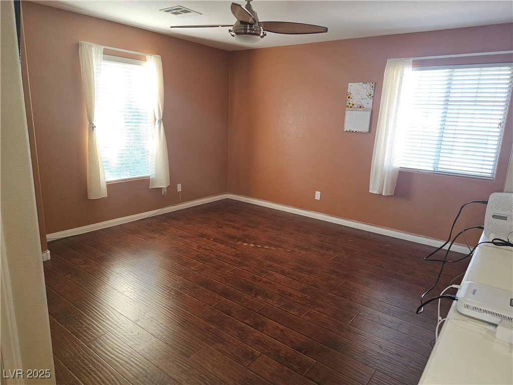 11081 Village Ridge Lane Las Vegas, NV 89135 - Photo 13 of 14 Empty room featuring dark wood finished floors and ceiling fan