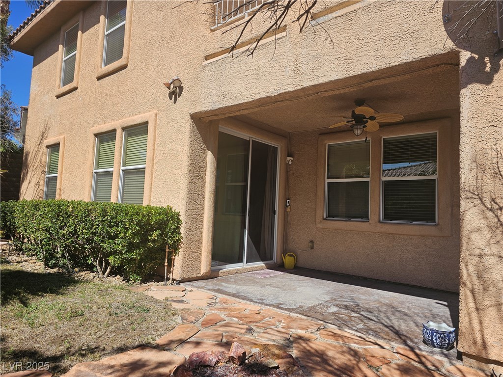 11081 Village Ridge Lane Las Vegas, NV 89135 - Photo 4 of 14 Doorway to property with a patio, ceiling fan, and stucco siding