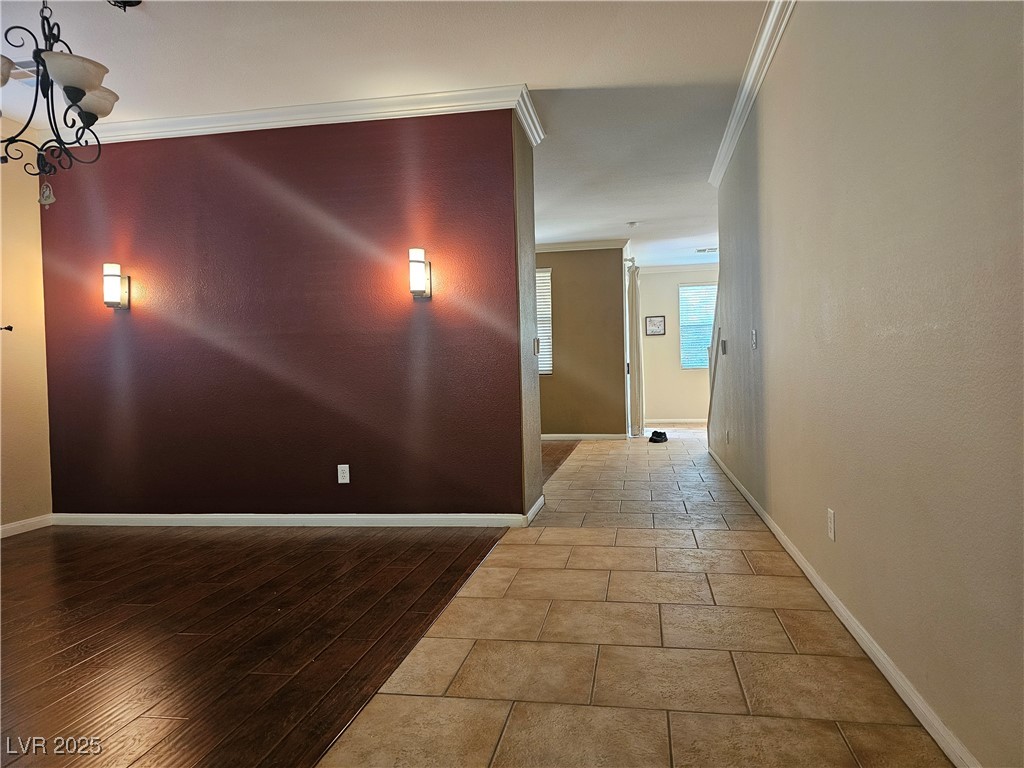 11081 Village Ridge Lane Las Vegas, NV 89135 - Photo 8 of 14 Corridor featuring crown molding, a chandelier, and light wood-type flooring