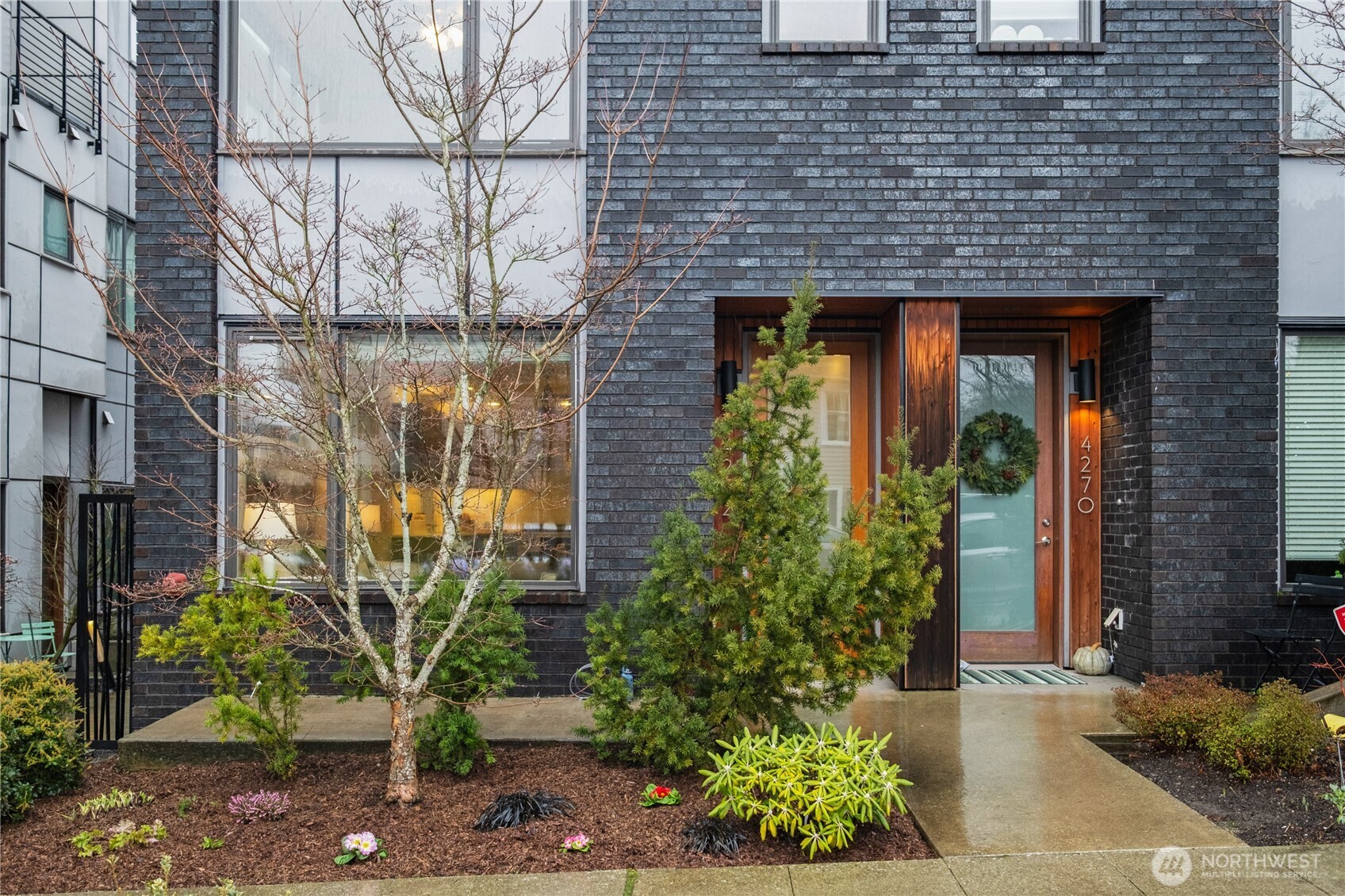 4272 Southwest Bradford Street Seattle, WA 98116 - Photo 3 of 28 a front view of a building with potted plants