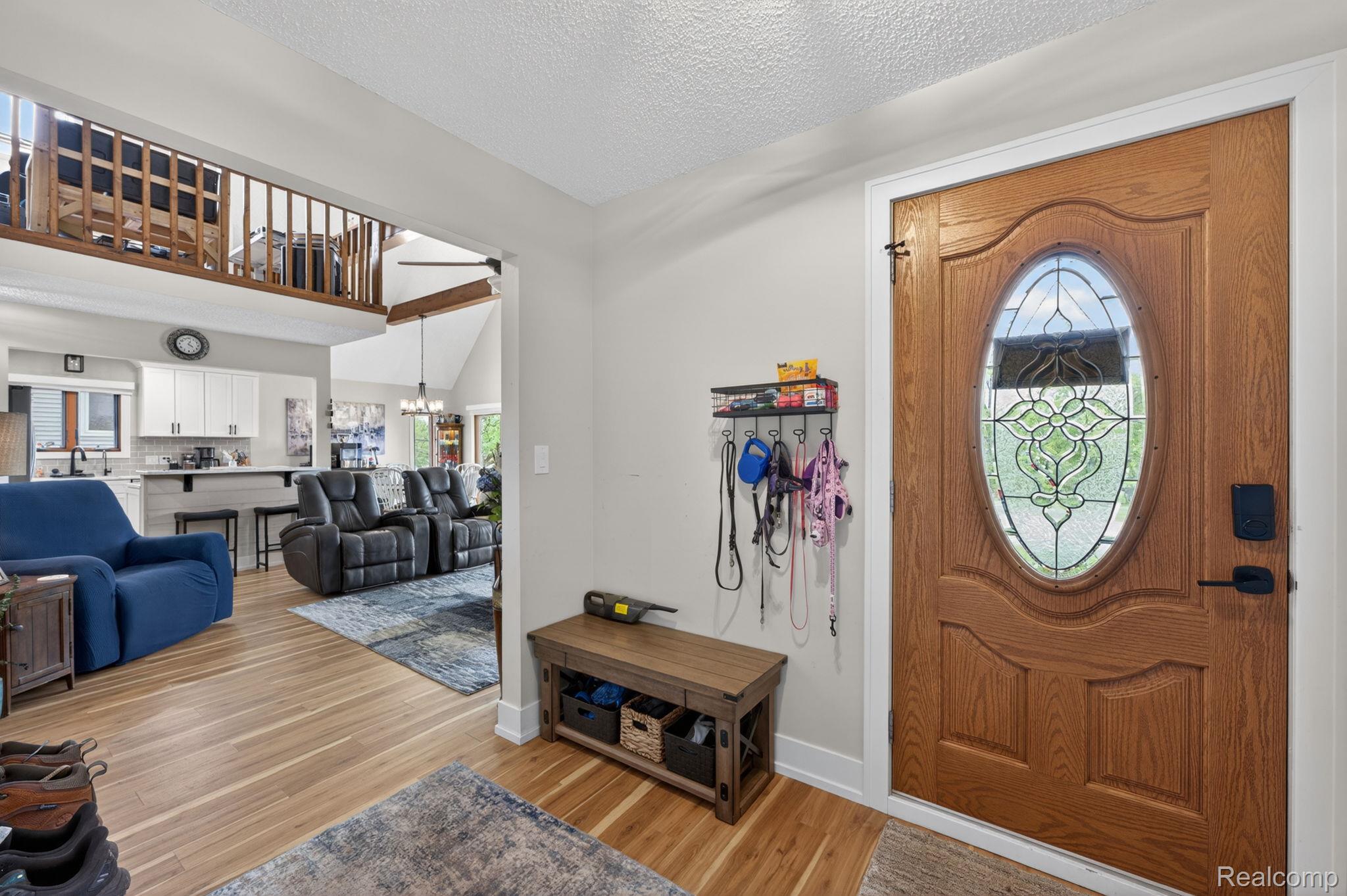 1280 Petts Road Fenton, MI 48430 - Photo 6 of 62 Entryway featuring light wood-type flooring and a chandelier