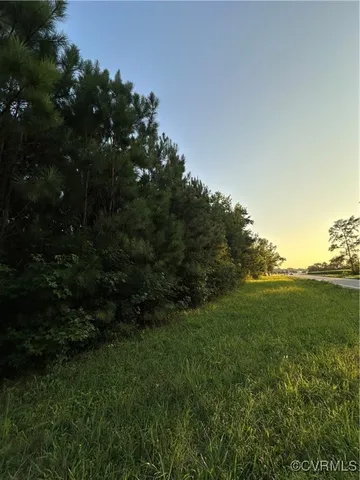 a view of a field of grass and trees