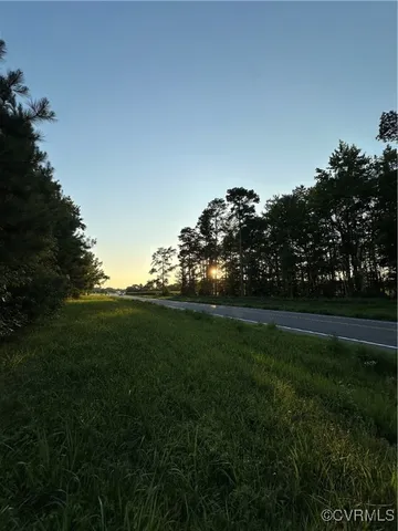a view of a field of grass and trees