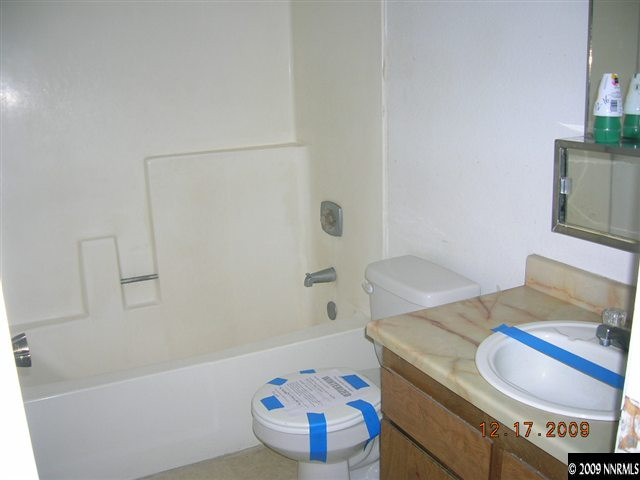 1402 East 9th Street, Unit 8 Reno, NV 89512 - Photo 8 of 9 a bathroom with a granite countertop sink and a mirror