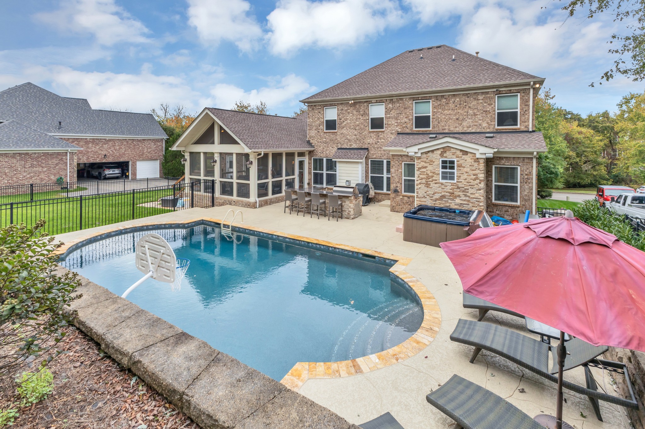 an aerial view of a house with swimming pool and porch
