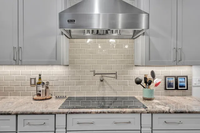 a kitchen with granite countertop stainless steel appliances granite counter tops and white cabinets