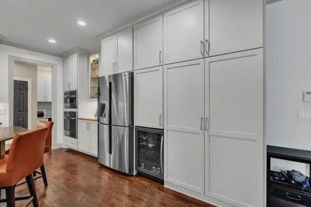a kitchen with stainless steel appliances a refrigerator and a wooden cabinets