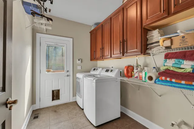 a view of staircase with wooden floor and a chandelier
