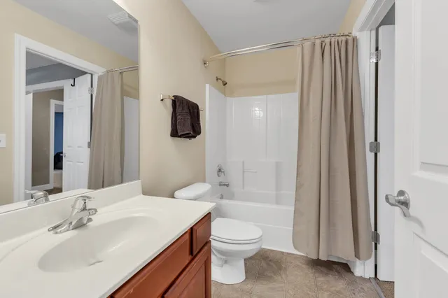 a bedroom with a bed and a ceiling fan