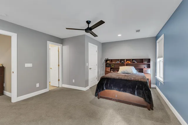 a view of a livingroom with a ceiling fan and entryway