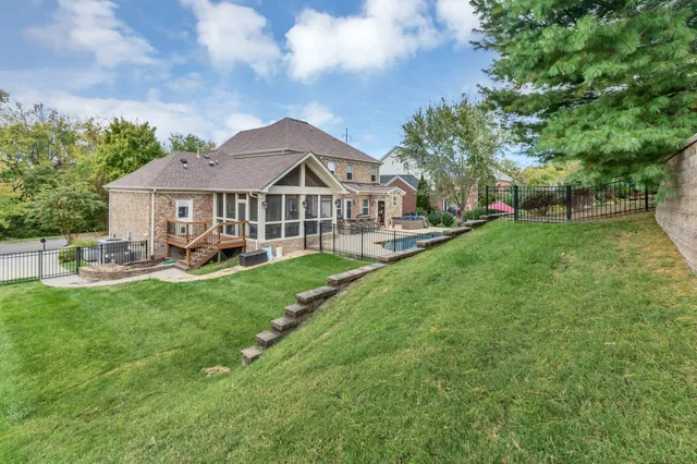 a view of a house with swimming pool and sitting area