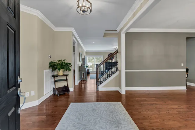 a view of an entryway with wooden floor