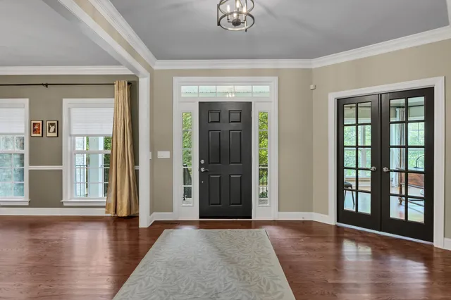 a view of an entryway with wooden floor and door