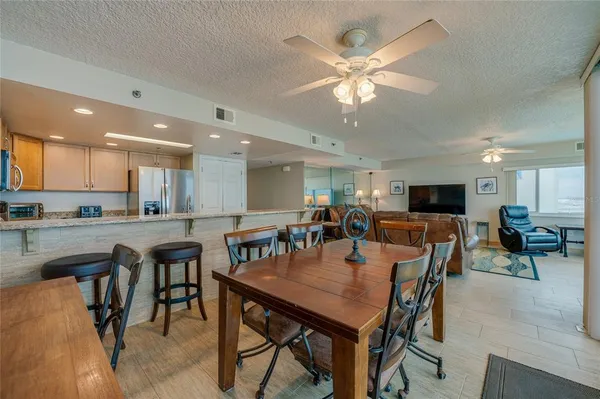 a view of a dining area with furniture and a kitchen