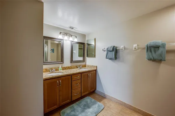 a bathroom with a double vanity sink and a mirror