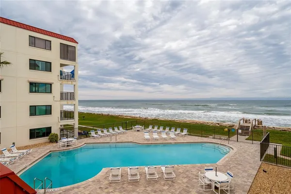 a view of a swimming pool with an ocean view
