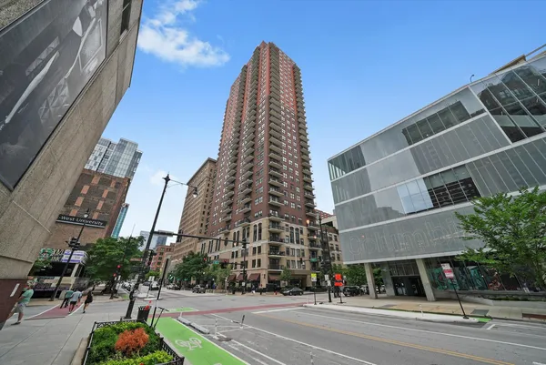 a view of a tall building next to a road