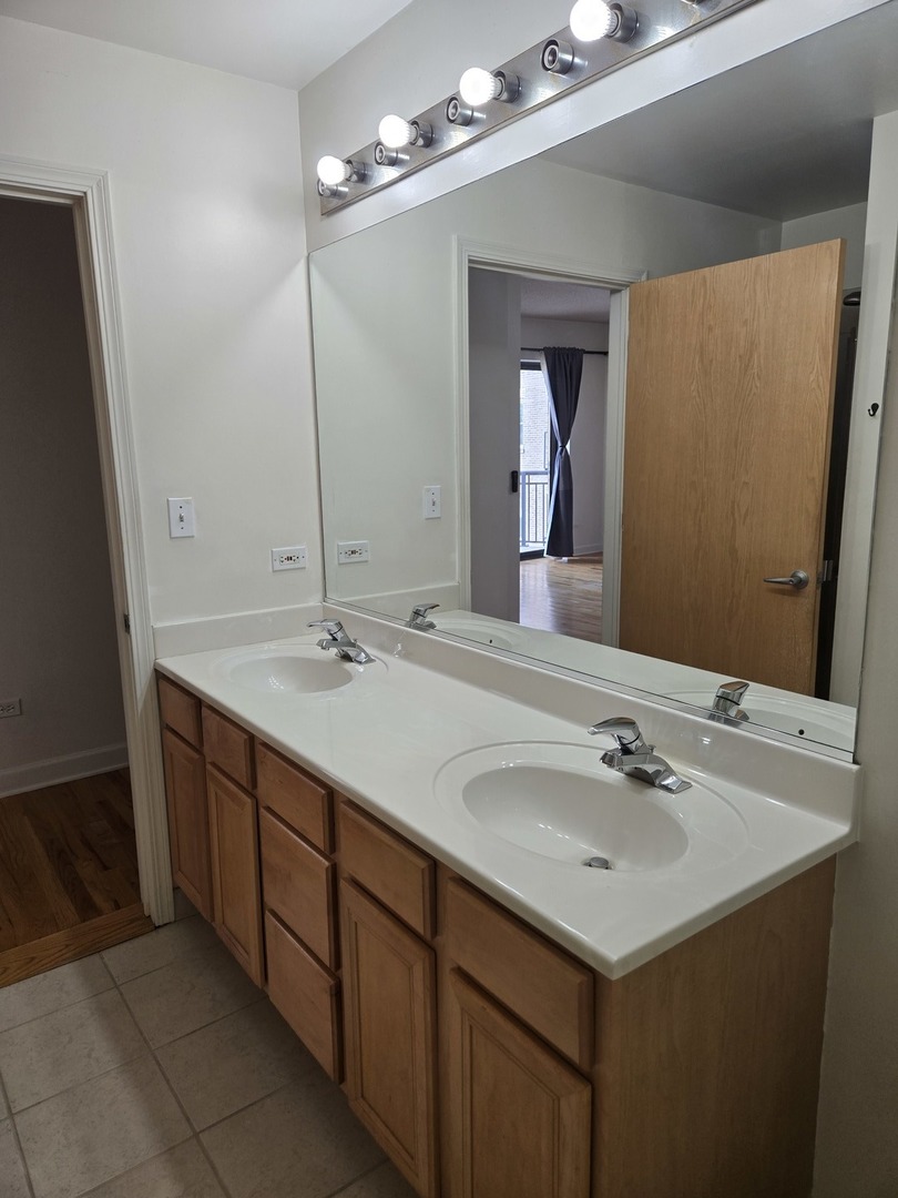 41 East 8th Street, Unit 1404 Chicago, IL 60605 - Photo 11 of 26 a bathroom with a sink and a mirror