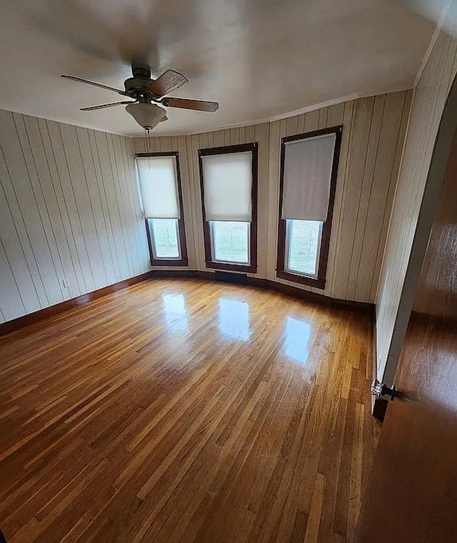 1100 John Stelle Road McLeansboro, IL 62859 - Photo 17 of 20 a view of an empty room with wooden floor and a window
